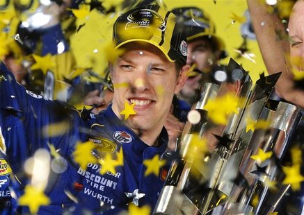 Brad Keselowski celebrates with the Sprint Cup which he clinched during the 2012 Ford EcoBoost 400 Sprint Cup NASCAR race, as confetti rains Brad Keselowski celebrates with the Sprint Cup which he clinched during the 2012 Ford EcoBoost 400 Sprint Cup NASCAR race, as confetti rains