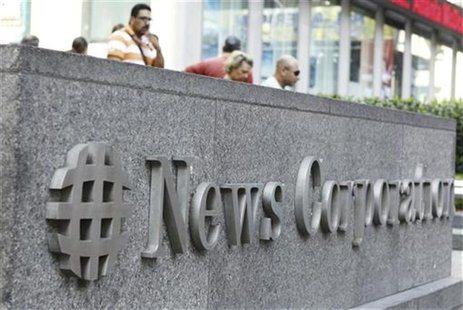 Pedestrians walk past a sign outside of the News Corporation Headquarters building in New York July 22, 2011. REUTERS/Lucas Jackson Pedestrians walk past a sign outside of the News Corporation Headquarters building in New York July 22, 2011. REUTERS/Lucas Jackson