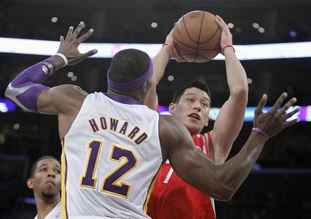 Houston Rockets point guard Jeremy Lin goes to the basket against Los Angeles Lakers center Dwight Howard (12) during their NBA basketball g Houston Rockets point guard Jeremy Lin goes to the basket against Los Angeles Lakers center Dwight Howard (12) during their NBA basketball g