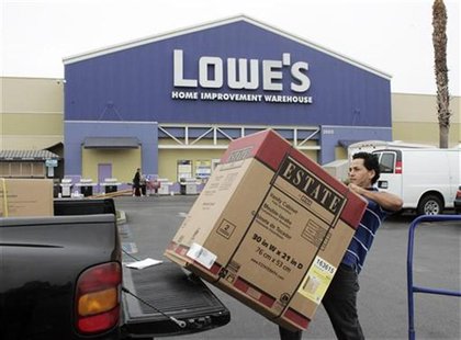 A contractor loads a bathroom vanity cabinet onto his truck after purchasing it at a Lowe's store in Burbank, California August 17, 2009. RE A contractor loads a bathroom vanity cabinet onto his truck after purchasing it at a Lowe's store in Burbank, California August 17, 2009. RE