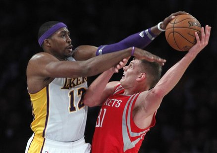 Los Angeles Lakers center Dwight Howard (12) blocks a shot by Houston Rockets center Cole Aldrich (R) during the second half of their NBA ba Los Angeles Lakers center Dwight Howard (12) blocks a shot by Houston Rockets center Cole Aldrich (R) during the second half of their NBA ba