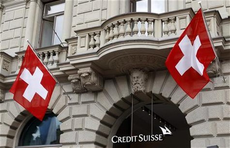 Switzerland national flags fly beside the logo of Swiss bank Credit Suisse (CS) at the company's headquarters in Zurich April 13, 2012. REUT Switzerland national flags fly beside the logo of Swiss bank Credit Suisse (CS) at the company's headquarters in Zurich April 13, 2012. REUT