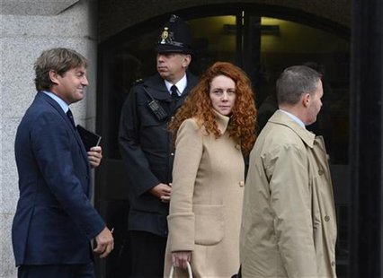 Former News International chief executive Rebekah Brooks and her husband Charlie (L) leave the Old Bailey court in London September 26, 2012 Former News International chief executive Rebekah Brooks and her husband Charlie (L) leave the Old Bailey court in London September 26, 2012