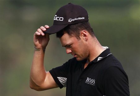 Martin Kaymer of Germany takes off his cap on the 18th green at the end of the third day of the WGC-HSBC Champions Tournament at Mission Hil Martin Kaymer of Germany takes off his cap on the 18th green at the end of the third day of the WGC-HSBC Champions Tournament at Mission Hil