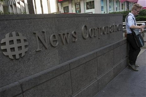 A passer-by stands in front of the News Corporation building in New York June 28, 2012. REUTERS/Keith Bedford A passer-by stands in front of the News Corporation building in New York June 28, 2012. REUTERS/Keith Bedford