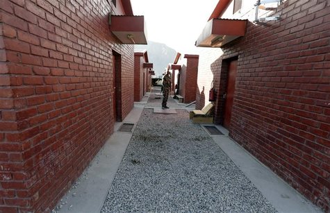 A French soldier walks between buildings at the empty forward base before a handover ceremony between the French army and the ANA (Afghan Na A French soldier walks between buildings at the empty forward base before a handover ceremony between the French army and the ANA (Afghan Na