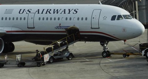 A worker is seen loading luggage on a plane from US Airways at Newark Liberty International Airport in Newark, New Jersey November 15, 2012. A worker is seen loading luggage on a plane from US Airways at Newark Liberty International Airport in Newark, New Jersey November 15, 2012.