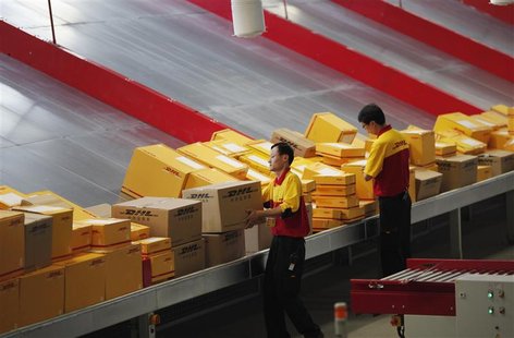 An employee carries a box at a workstation during an operational test of the new DHL North Asia Hub in Shanghai in this July 12, 2012 file p An employee carries a box at a workstation during an operational test of the new DHL North Asia Hub in Shanghai in this July 12, 2012 file p