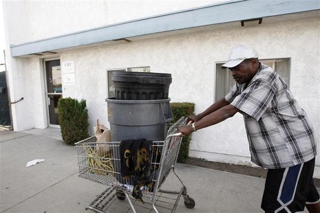 Carnell Weathersby pushes the cart he uses for collecting recyclables after picking up food from the Foothill Unity Center food bank in Monr Carnell Weathersby pushes the cart he uses for collecting recyclables after picking up food from the Foothill Unity Center food bank in Monr