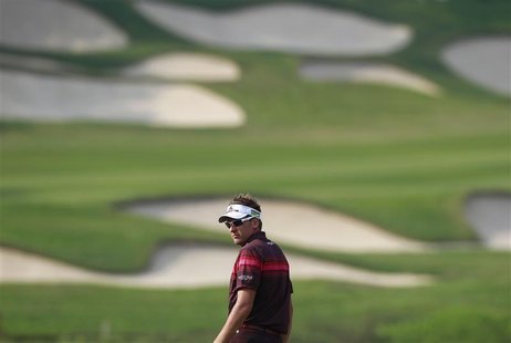 Ian Poulter of England looks back on the 15th fairway during the final day of the WGC-HSBC Champions Tournament at Mission Hills in the sout Ian Poulter of England looks back on the 15th fairway during the final day of the WGC-HSBC Champions Tournament at Mission Hills in the sout
