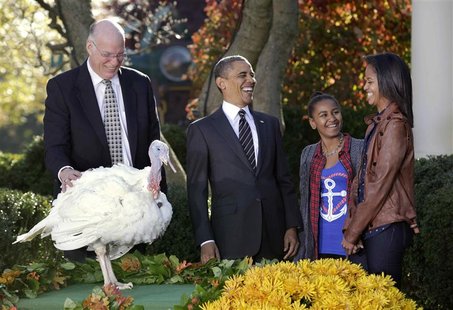 U.S. President Barack Obama laughs with his daughters Sasha and Malia (R) as he pardons National Thanksgiving Turkey, Cobbler, in The Rose G U.S. President Barack Obama laughs with his daughters Sasha and Malia (R) as he pardons National Thanksgiving Turkey, Cobbler, in The Rose G