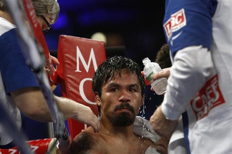 WBO welterweight champion Manny Pacquiao of the Philippines is treated in his corner between rounds during his title fight against Timothy B WBO welterweight champion Manny Pacquiao of the Philippines is treated in his corner between rounds during his title fight against Timothy B