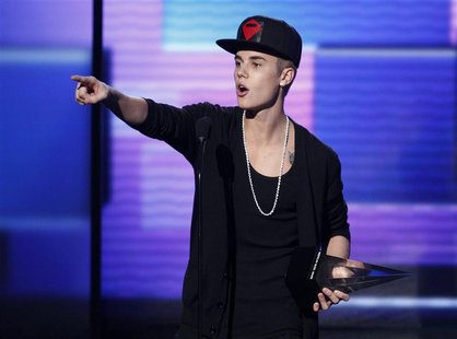 Justin Bieber accepts the award for favorite pop rock album for "Believe" at the 40th American Music Awards in Los Angeles, California, Nove Justin Bieber accepts the award for favorite pop rock album for "Believe" at the 40th American Music Awards in Los Angeles, California, Nove