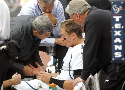 Jacksonville Jaguars quarterback Blaine Gabbert is examined on the bench after he was injured being sacked by Houston Texans safety Danieal Jacksonville Jaguars quarterback Blaine Gabbert is examined on the bench after he was injured being sacked by Houston Texans safety Danieal