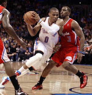 Oklahoma City Thunder guard Russell Westbrook passes Los Angeles Clippers guard Chris Paul (R) in the first half of their NBA basketball gam Oklahoma City Thunder guard Russell Westbrook passes Los Angeles Clippers guard Chris Paul (R) in the first half of their NBA basketball gam