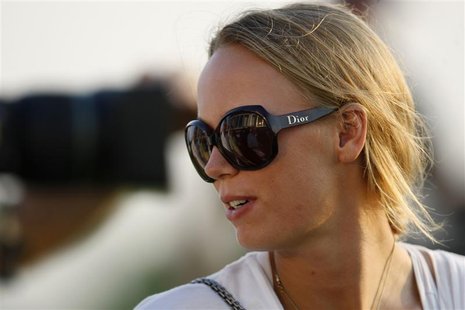 Denmark's professional tennis player Caroline Wozniacki looks on near the 18th green during the first round of the DP World Tour Championshi Denmark's professional tennis player Caroline Wozniacki looks on near the 18th green during the first round of the DP World Tour Championshi
