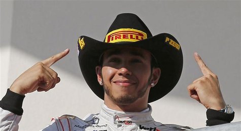McLaren Formula One driver Lewis Hamilton of Britain gestures during the podium ceremony after winning the U.S. F1 Grand Prix at the Circuit McLaren Formula One driver Lewis Hamilton of Britain gestures during the podium ceremony after winning the U.S. F1 Grand Prix at the Circuit