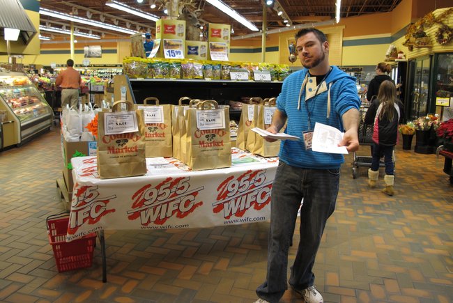 Mike Mathers handing out a list of the items we need for the Neighbor's Place...work it Mike!