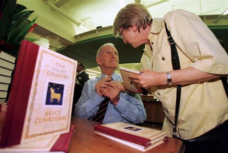 Author Bryce Courtenay (L) holds the hand of a lady after he signed a copy of his latest book titled "The Night Country" for her at a Sydney Author Bryce Courtenay (L) holds the hand of a lady after he signed a copy of his latest book titled "The Night Country" for her at a Sydney