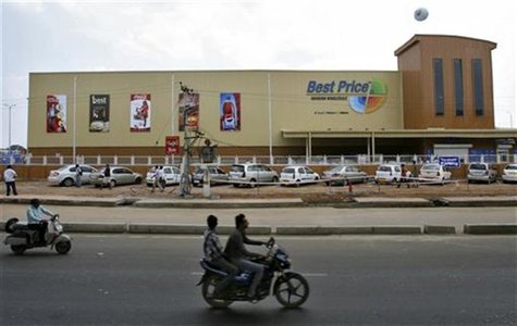 Two-wheelers move past the newly opened Bharti Wal-Mart Best Price Modern wholesale store in the southern Indian city of Hyderabad September Two-wheelers move past the newly opened Bharti Wal-Mart Best Price Modern wholesale store in the southern Indian city of Hyderabad September