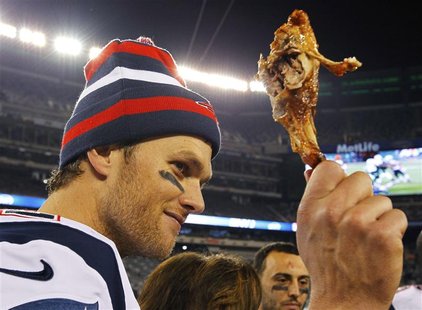 New England Patriots quarterback Tom Brady holds up a turkey leg after they defeated the New York Jets in their NFL football game in East Ru New England Patriots quarterback Tom Brady holds up a turkey leg after they defeated the New York Jets in their NFL football game in East Ru