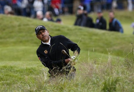 Jeev Milkha Singh watches his shot from the rough on the 15th hole during the second round of the British Open golf championship at Royal Ly Jeev Milkha Singh watches his shot from the rough on the 15th hole during the second round of the British Open golf championship at Royal Ly