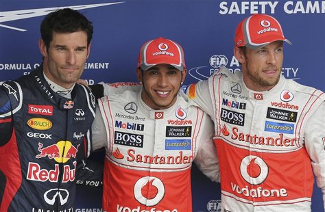 (L to R) Red Bull Formula One driver Mark Webber of Australia, McLaren drivers Lewis Hamilton and Jenson Button of Britain pose for photos a (L to R) Red Bull Formula One driver Mark Webber of Australia, McLaren drivers Lewis Hamilton and Jenson Button of Britain pose for photos a
