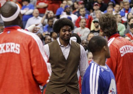 Injured Philadelphia 76ers center Andrew Bynum (C) smiles before the start of the NBA basketball game between the 76ers and the Denver Nugge Injured Philadelphia 76ers center Andrew Bynum (C) smiles before the start of the NBA basketball game between the 76ers and the Denver Nugge