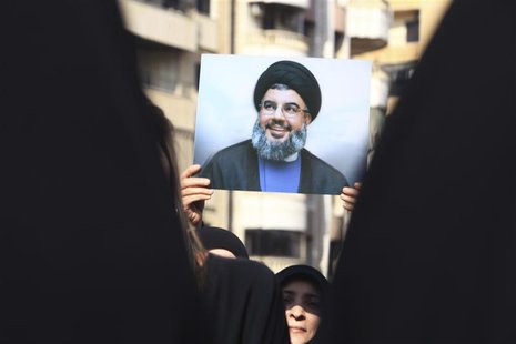 A Lebanese Hezbollah supporter carries a picture of Hezbollah leader Sayyed Hassan Nasrallah as she takes part in a ceremony marking Ashura A Lebanese Hezbollah supporter carries a picture of Hezbollah leader Sayyed Hassan Nasrallah as she takes part in a ceremony marking Ashura