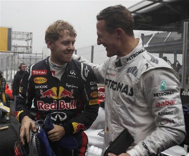Mercedes Formula One driver Michael Schumacher of Germany (R) congratulates compatriot Red Bull driver Sebastian Vettel after the Brazilian Mercedes Formula One driver Michael Schumacher of Germany (R) congratulates compatriot Red Bull driver Sebastian Vettel after the Brazilian