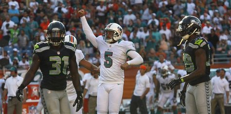 Seattle Seahawks Kam Chancellor ( L ) and Brandon Browner look on as Miami Dolphins' Placekicker Dan Carpenter reacts to scoring the game wi Seattle Seahawks Kam Chancellor ( L ) and Brandon Browner look on as Miami Dolphins' Placekicker Dan Carpenter reacts to scoring the game wi