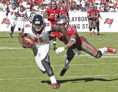 Atlanta Falcons wide receiver Julio Jones (11) races away from Tampa Bay Buccaneers cornerback Leonard Johnson (29) to score on an 80 yard p Atlanta Falcons wide receiver Julio Jones (11) races away from Tampa Bay Buccaneers cornerback Leonard Johnson (29) to score on an 80 yard p