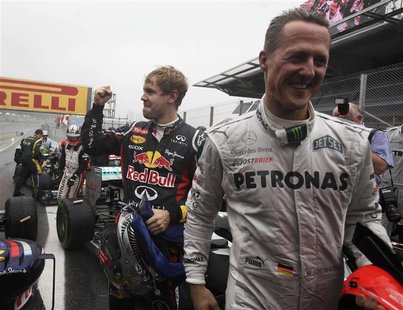 Red Bull Formula One driver Sebastian Vettel of Germany (L) celebrates winning the world championship next to compatriot Mercedes driver Mic Red Bull Formula One driver Sebastian Vettel of Germany (L) celebrates winning the world championship next to compatriot Mercedes driver Mic