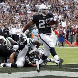 While as a member of the Oakland Raiders, current Chicago Bears RB Michael Bush scores a touchdown against the New York Jets during the second half of their NFL football game in Oakland, California September 25, 2011. REUTERS/Robert Galbraith 