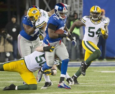 New York Giants running back Andre Brown (35) breaks past Green Bay Packers inside linebacker A.J. Hawk (bottom L) and linebacker Dezman Mos New York Giants running back Andre Brown (35) breaks past Green Bay Packers inside linebacker A.J. Hawk (bottom L) and linebacker Dezman Mos