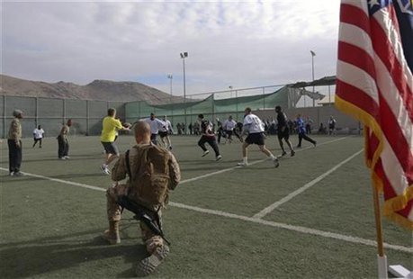 U.S. troops play touch football in the early morning hours on Thanksgiving at a military base in Kabul, November 22, 2012. REUTERS/Omar Sobh U.S. troops play touch football in the early morning hours on Thanksgiving at a military base in Kabul, November 22, 2012. REUTERS/Omar Sobh