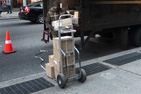 A UPS delivery man unloads boxes from a truck in New York November 26, 2012. Cyber Monday's online sales got off to a brisk start, sending e A UPS delivery man unloads boxes from a truck in New York November 26, 2012. Cyber Monday's online sales got off to a brisk start, sending e