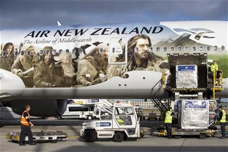 An Air New Zealand Boeing 777-300ER featuring livery advertising the film The Hobbit: An Unexpected Journey is loaded by ground crew after l An Air New Zealand Boeing 777-300ER featuring livery advertising the film The Hobbit: An Unexpected Journey is loaded by ground crew after l