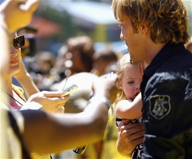 Larry Birkhead, ex-boyfriend of the late Anna Nicole Smith, holds his daughter Dannielynn as he is being interviewed at the opening of The S Larry Birkhead, ex-boyfriend of the late Anna Nicole Smith, holds his daughter Dannielynn as he is being interviewed at the opening of The S