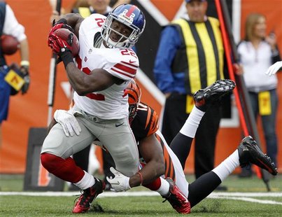 New York Giants' David Wilson (22) is tackled by Cincinnati Bengals' Mohamed Sanu (12) during the first half of play in their NFL football g New York Giants' David Wilson (22) is tackled by Cincinnati Bengals' Mohamed Sanu (12) during the first half of play in their NFL football g