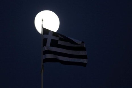 A Greek flag flutters in front of the moon in Athens November 26, 2012. REUTERS/Yorgos Karahalis A Greek flag flutters in front of the moon in Athens November 26, 2012. REUTERS/Yorgos Karahalis