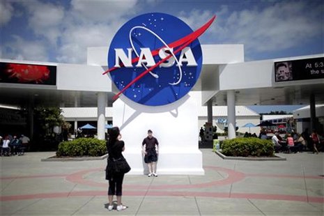 Tourists take pictures of a NASA sign at the Kennedy Space Center visitors complex in Cape Canaveral, Florida April 14, 2010. REUTERS/Carlos Tourists take pictures of a NASA sign at the Kennedy Space Center visitors complex in Cape Canaveral, Florida April 14, 2010. REUTERS/Carlos