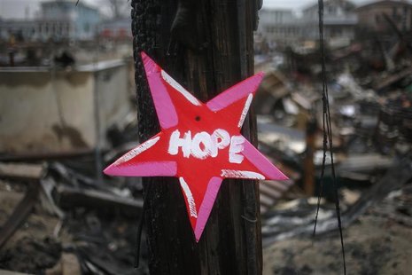 A wooden star with the word "Hope", is left in front of a burnt house in Breezy Point, almost a month after the neighborhood was left devast A wooden star with the word "Hope", is left in front of a burnt house in Breezy Point, almost a month after the neighborhood was left devast