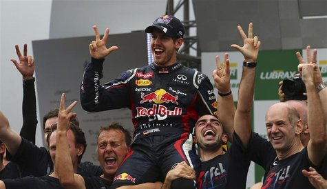 Red Bull Formula One driver Sebastian Vettel of Germany (C) celebrates winning the world championship with Team Principal Chrisian Horner (L Red Bull Formula One driver Sebastian Vettel of Germany (C) celebrates winning the world championship with Team Principal Chrisian Horner (L