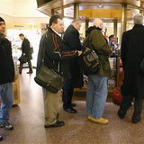 People line up to buy Powerball tickets from a newsstand inside Grand Central Station in New York, November 27, 2012. The jackpot for the Powerball lottery soared on Tuesday to a record $500 million and could increase again by the time the winning numbers are drawn on Wednesday, a lottery official said. 
REUTERS/Carlo Allegri
