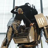Japanese artist Kogoro Kurata, inventor of the giant "Kuratas" robot, climbs out of its cockpit at an exhibition in Tokyo November 28, 2012.