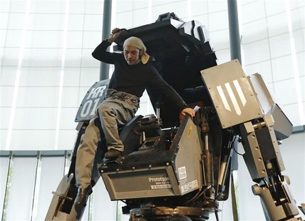Japanese artist Kogoro Kurata, inventor of the giant "Kuratas" robot, climbs out of its cockpit at an exhibition in Tokyo November 28, 2012. Japanese artist Kogoro Kurata, inventor of the giant "Kuratas" robot, climbs out of its cockpit at an exhibition in Tokyo November 28, 2012.