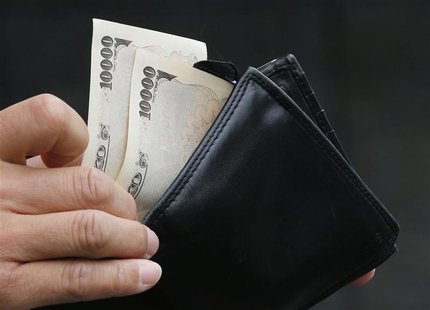 A man holds Japanese 10,000 Yen ($121) bank notes in front of a bank in Tokyo November 22, 2012. REUTERS/Kim Kyung-Hoon A man holds Japanese 10,000 Yen ($121) bank notes in front of a bank in Tokyo November 22, 2012. REUTERS/Kim Kyung-Hoon