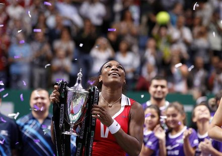Serena Williams of the U.S. celebrates with the trophy after her victory against Russia's Maria Sharapova after their final WTA tennis champ Serena Williams of the U.S. celebrates with the trophy after her victory against Russia's Maria Sharapova after their final WTA tennis champ