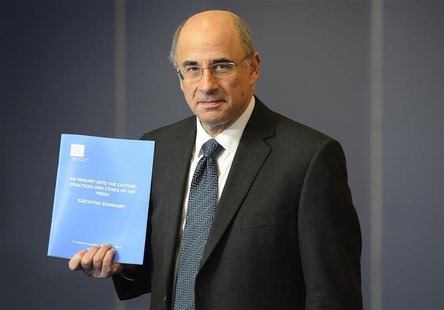 Lord Justice Brian Leveson poses with an executive summary of his report following an inquiry into media practices in central London Novembe Lord Justice Brian Leveson poses with an executive summary of his report following an inquiry into media practices in central London Novembe